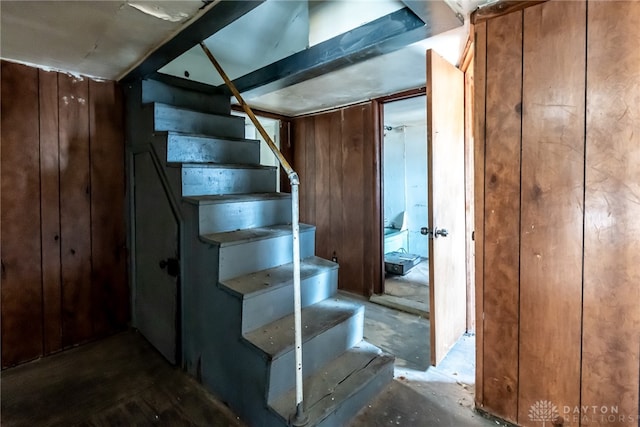 stairs featuring wooden walls