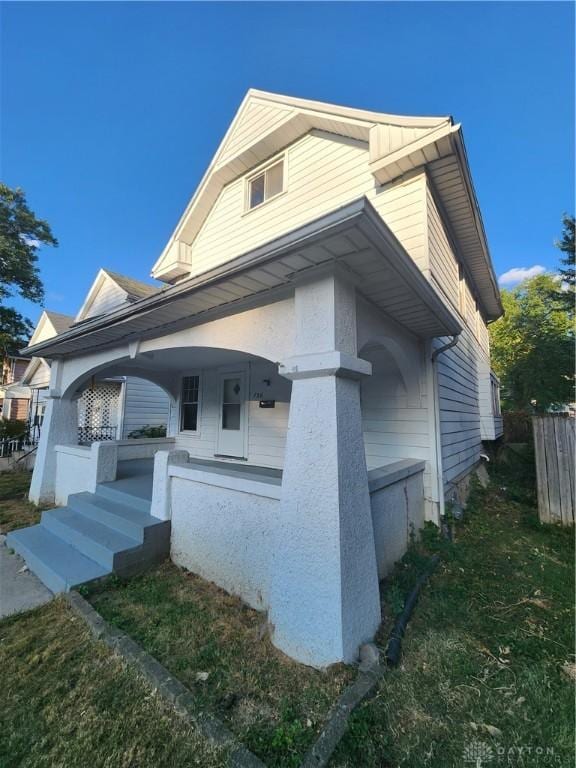 view of side of property featuring a porch