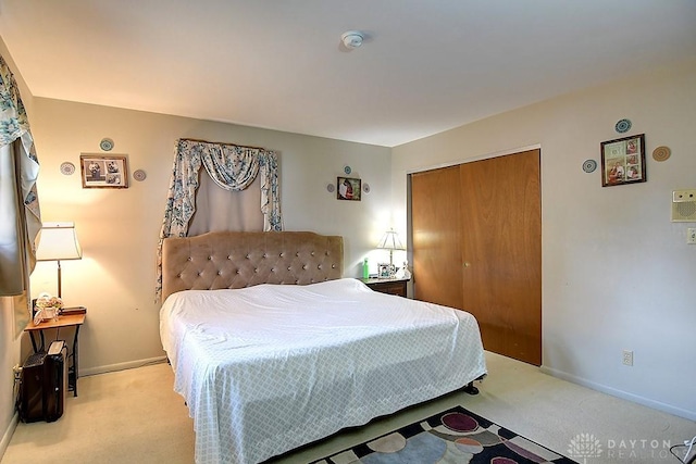 bedroom with carpet floors, a closet, and baseboards