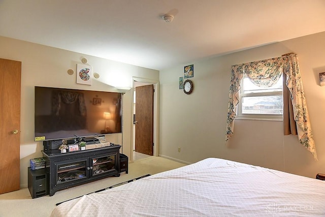 carpeted bedroom featuring baseboards