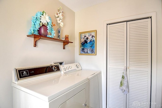 laundry area with laundry area and washer and clothes dryer