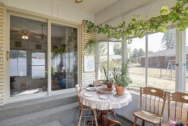 sunroom with a ceiling fan