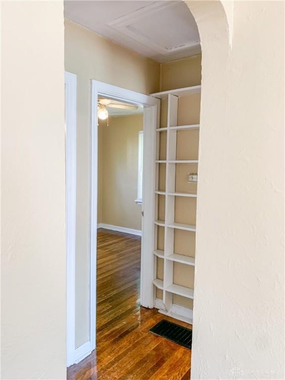 corridor with dark hardwood / wood-style flooring