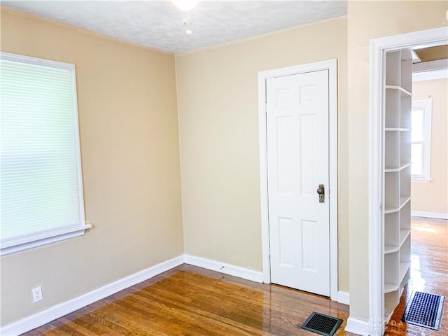 empty room featuring wood-type flooring