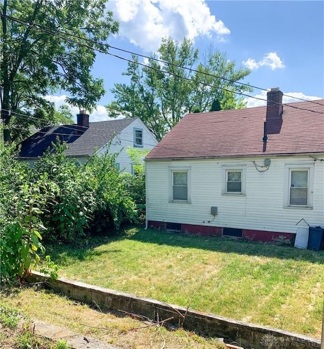 view of side of home featuring a lawn