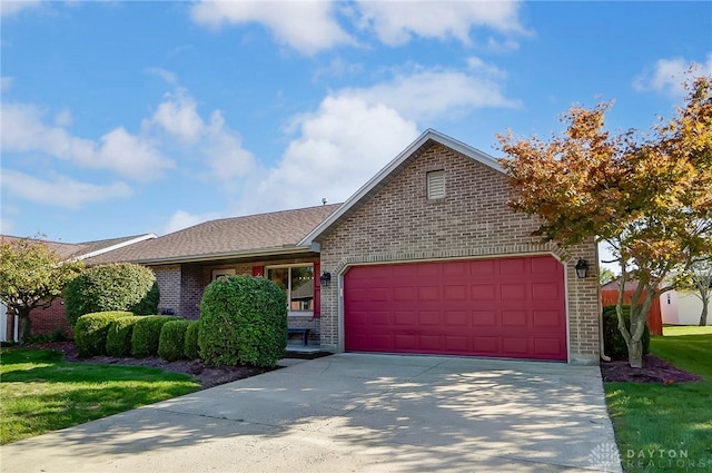 single story home with a front yard and a garage