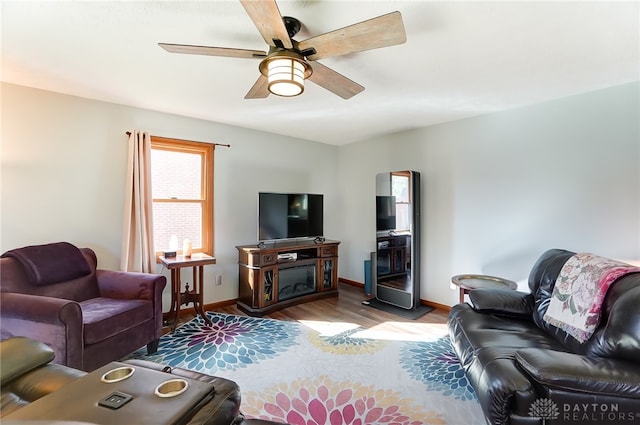 living room featuring light hardwood / wood-style flooring and ceiling fan