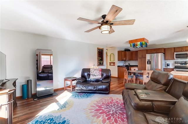 living room with ceiling fan and dark wood-type flooring