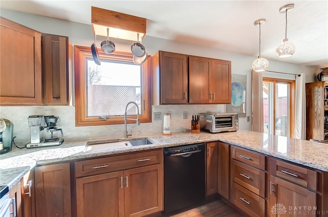 kitchen with dishwasher, pendant lighting, plenty of natural light, and sink