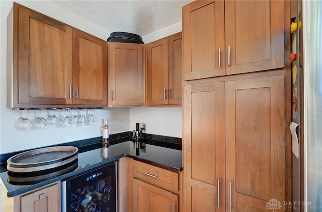 kitchen with a textured ceiling and wine cooler