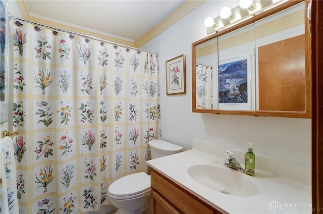 bathroom featuring curtained shower, vanity, and toilet