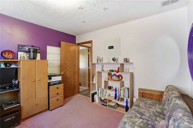 sitting room featuring carpet flooring and a textured ceiling