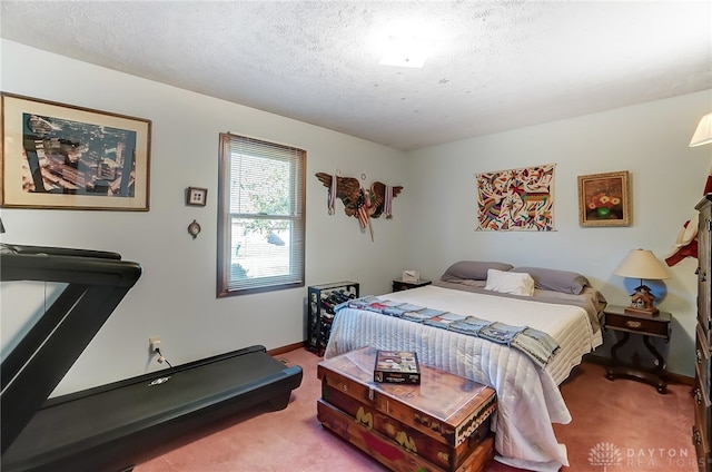 carpeted bedroom featuring a textured ceiling