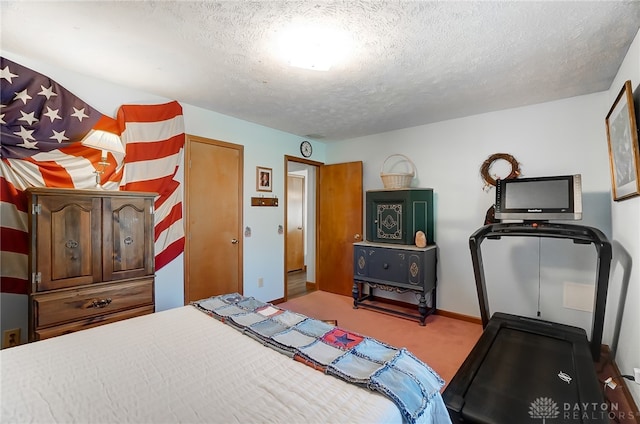 bedroom featuring carpet and a textured ceiling