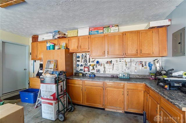 kitchen with a textured ceiling and electric panel