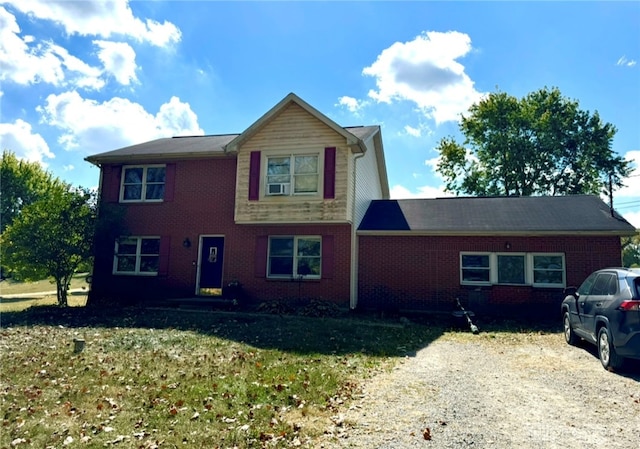 view of front of home with a front yard and cooling unit