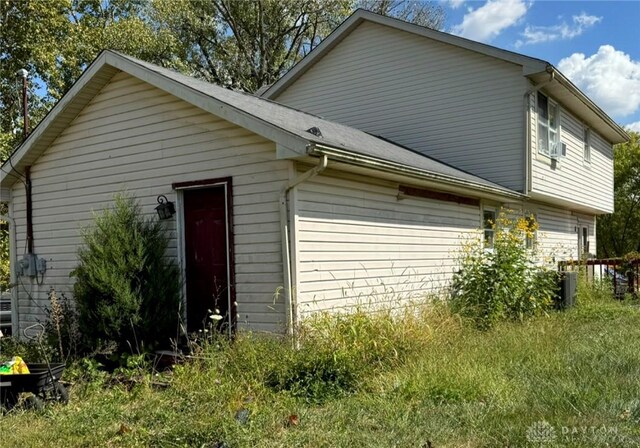 view of side of home featuring central AC unit