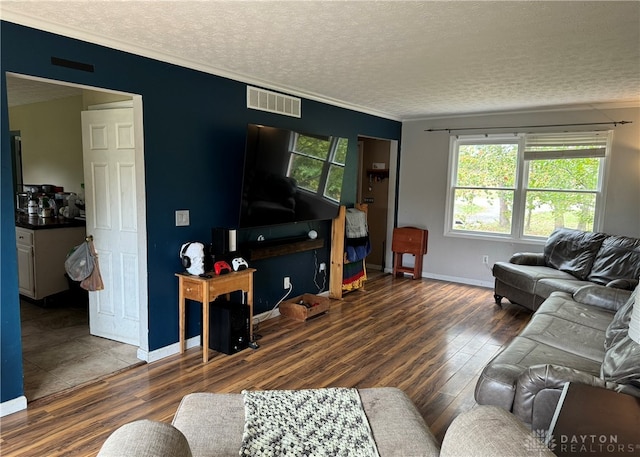 living room featuring a textured ceiling, crown molding, and dark hardwood / wood-style flooring