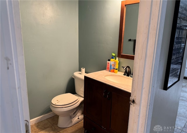 bathroom featuring tile patterned flooring, vanity, and toilet