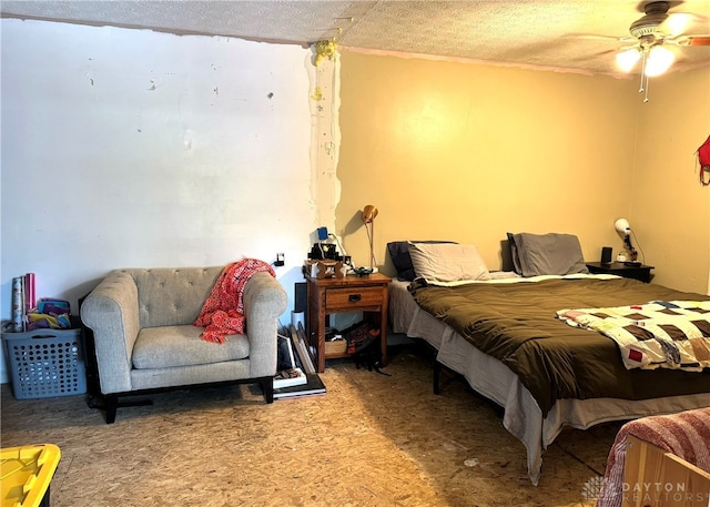 bedroom featuring a textured ceiling, carpet flooring, and ceiling fan