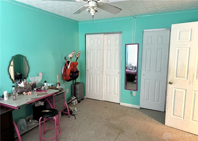 office space featuring ceiling fan, a textured ceiling, and carpet