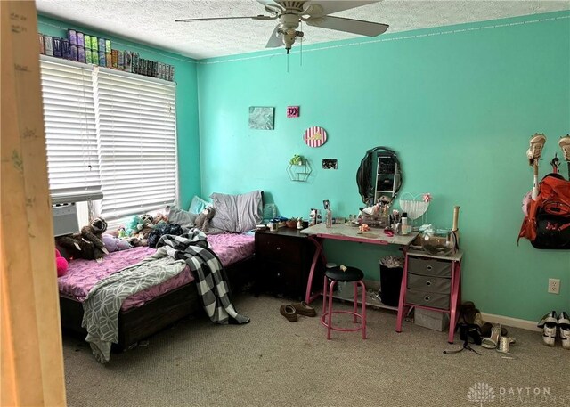 bedroom with a textured ceiling, carpet, and ceiling fan