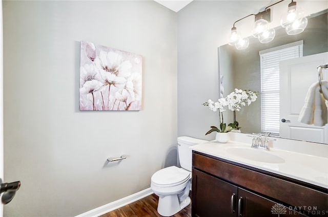 bathroom with vanity, hardwood / wood-style flooring, and toilet