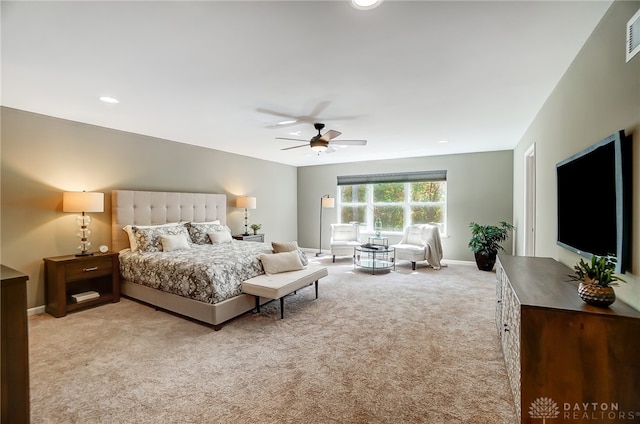 bedroom with ceiling fan and light carpet