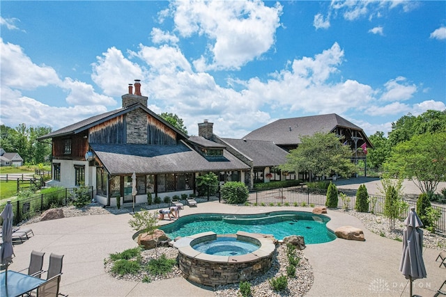 view of pool with a patio area and an in ground hot tub