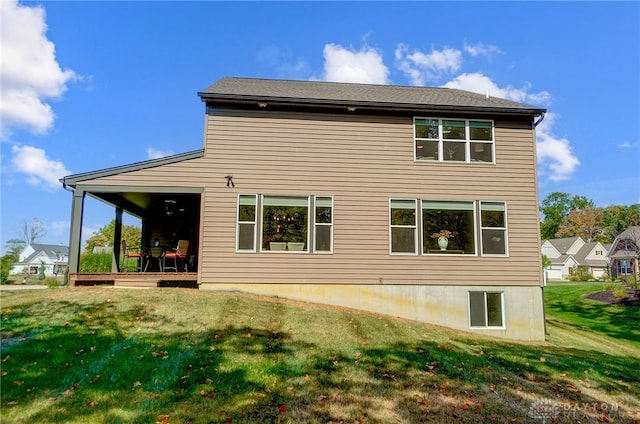 rear view of property with a lawn