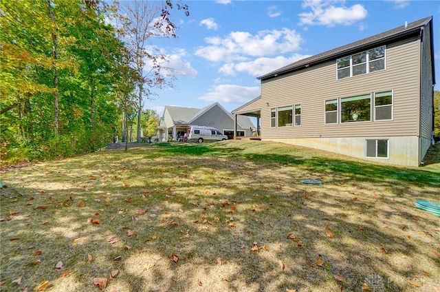 rear view of property featuring a lawn