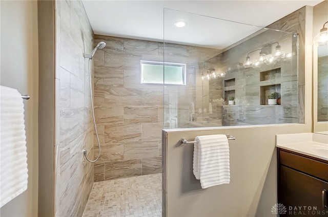 bathroom featuring vanity and tiled shower