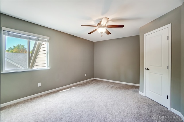 unfurnished room featuring ceiling fan and carpet floors