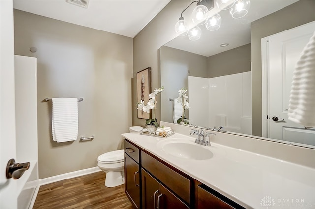 bathroom with hardwood / wood-style flooring, vanity, and toilet