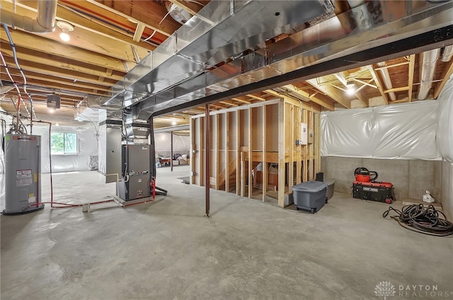 basement featuring heating unit and water heater