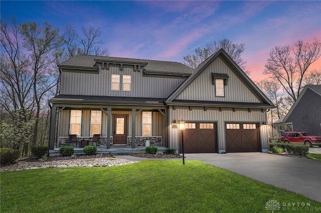 view of front of home with covered porch and a yard