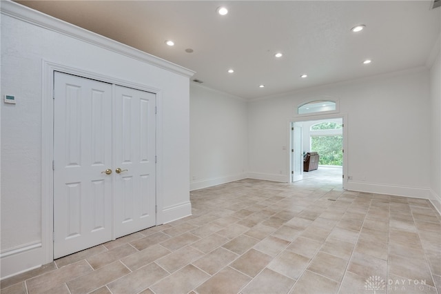 unfurnished room with crown molding