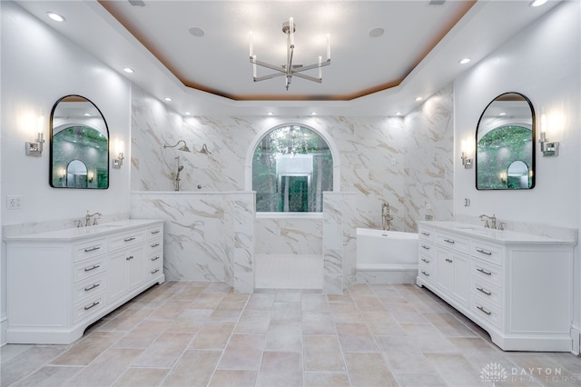 bathroom with tile walls, tile patterned flooring, a bath, and vanity