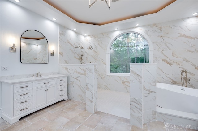 bathroom featuring a bathtub, tile walls, and vanity