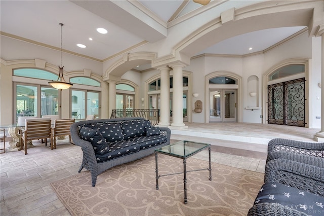 living room with crown molding, light hardwood / wood-style flooring, and ornate columns