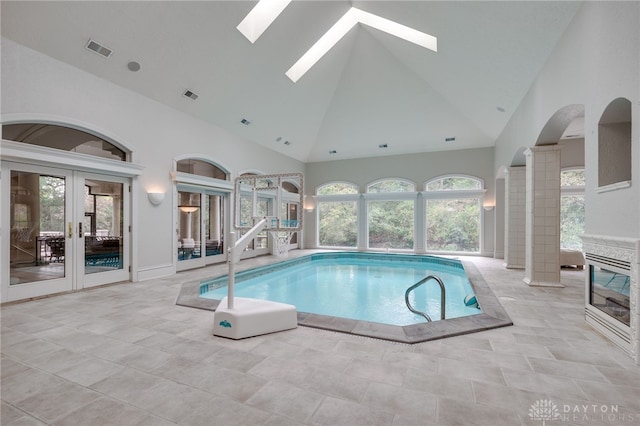 view of swimming pool with a skylight and french doors