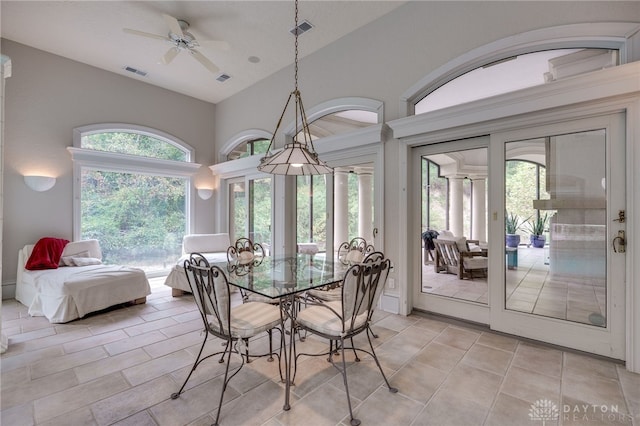 dining space with lofted ceiling, ceiling fan, and light tile patterned floors