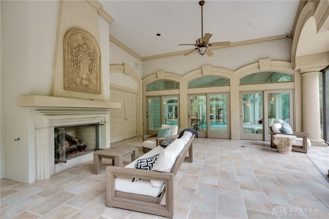 interior space featuring light tile patterned flooring, ornamental molding, ceiling fan, and a wealth of natural light