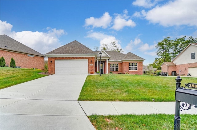 view of front facade with a garage and a front lawn