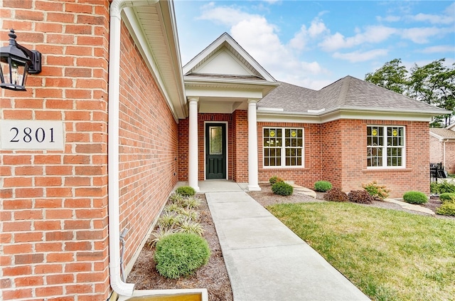 entrance to property featuring a yard