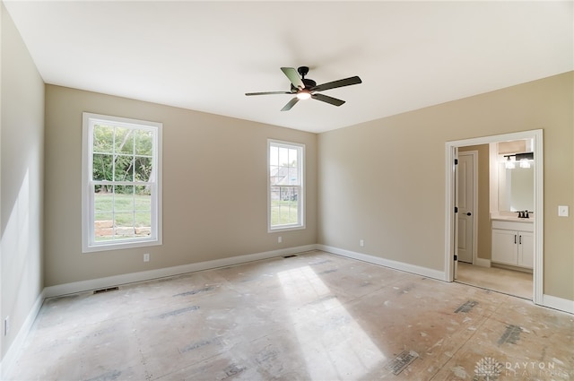 unfurnished bedroom with connected bathroom and ceiling fan