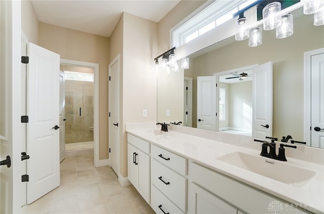 bathroom with walk in shower, a healthy amount of sunlight, vanity, and ceiling fan