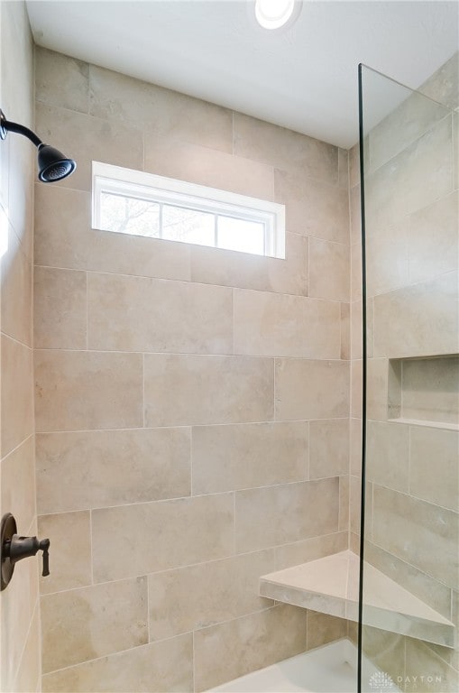 bathroom with a tile shower