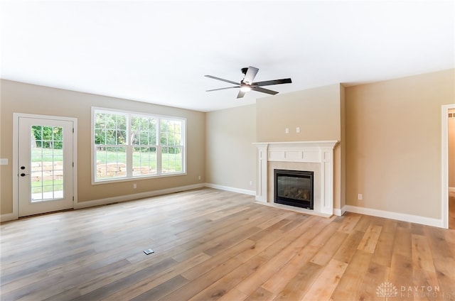 unfurnished living room featuring light hardwood / wood-style flooring and ceiling fan