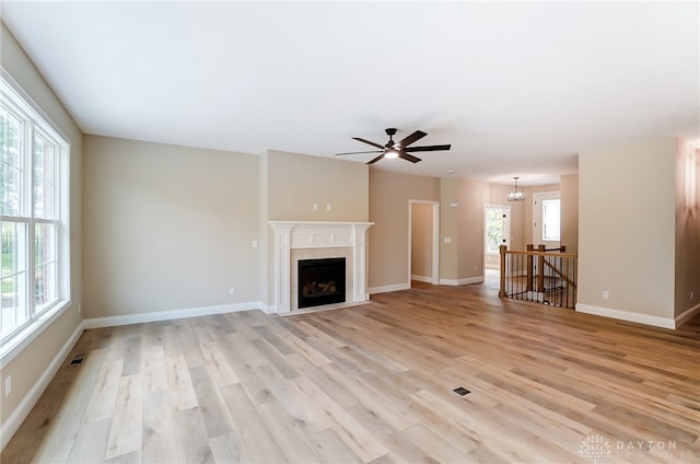 unfurnished living room featuring ceiling fan and light hardwood / wood-style flooring